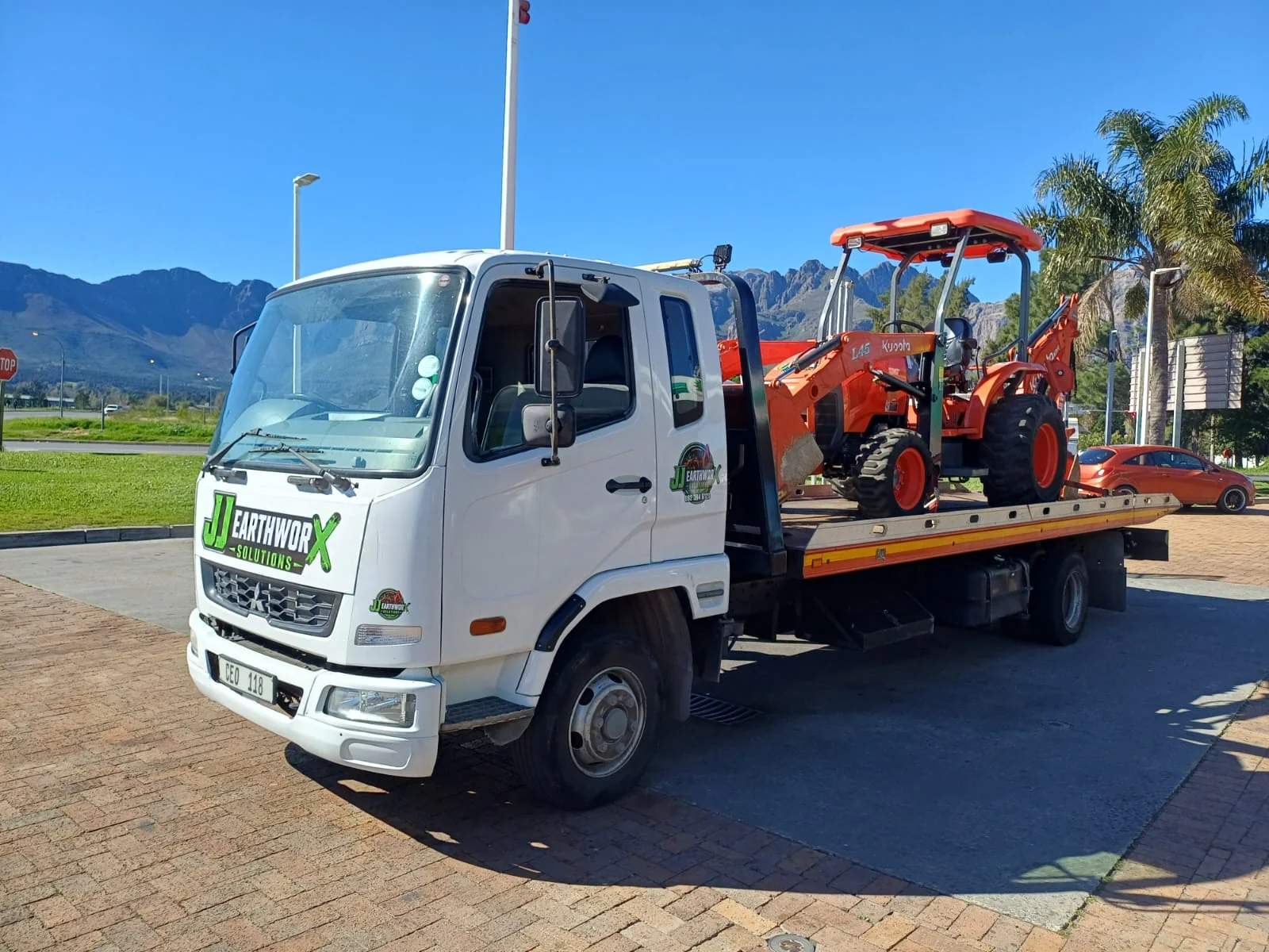 Mini digger excavator working on a construction site with earth being moved