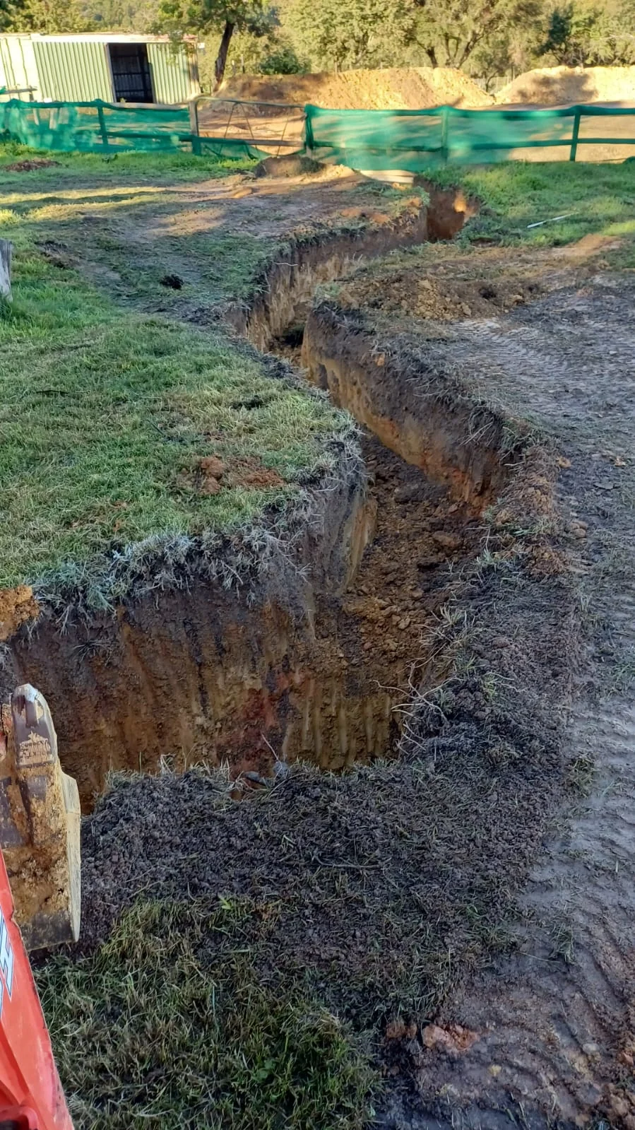 Mini digger performing precise excavation work on a residential site